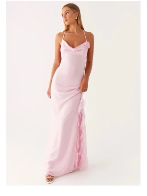 Ljusrosa långklänning med volang - Elegant ljusrosa långklänning från peppermayo med tunna axelband och dekorativ blomdetalj vid axeln. Klänningen har en vacker volang längs sidan och en slits som ger extra rörelse. Materialet är att vara mjukt och följsamt, perfekt för speciella tillfällen. Klänningen är helt ny och kommer i orginalförpackning! Den är storlek 38 men är liten i storlek och passar därför bättre 34/36