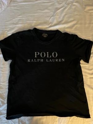 Ralph Lauren t shirt - Schysst svart Polo Ralph Lauren! Väldigt snygg till sommaren. Säljer pga växt ifrån storleken.