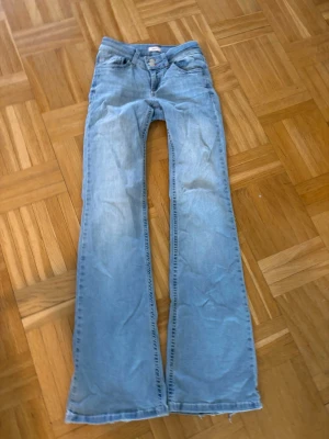 Nelly lågmidjade bootcut ljusblåa jeans - Storlek 34 passat perfekt mellan 167-170 cm lång mycket bra skicka lite slit längst ner men annars perfekta.