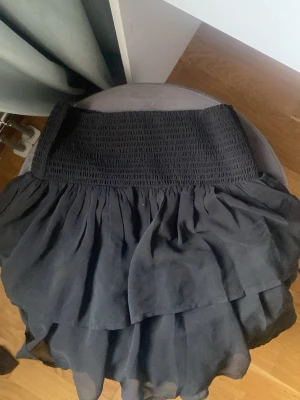 Svart volangkjol - En svart vanlig volangkjol i storlek 170 