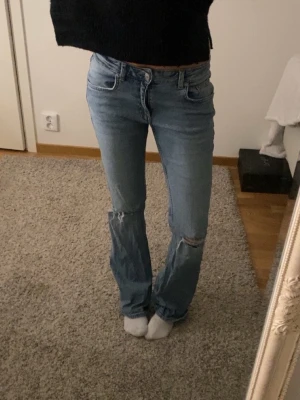 Ljusblå bootcut jeans med låg midja - Snygga ljusblå bootcut jeans med hål  och låg midja 