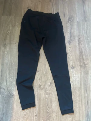 Svarta leggings med hög midja 158-164cm - Säljer ett par svarta leggings med hög midja och smal passform. De är stretchiga och har en enkel, stilren design utan synliga detaljer eller loggor. Perfekta att matcha med oversized tröjor eller hoodies.