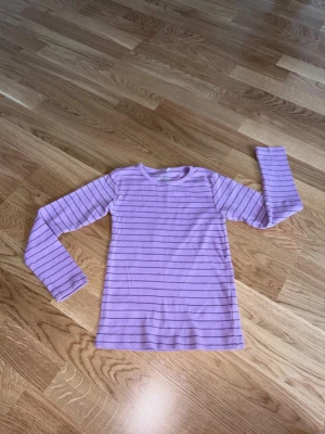 Topp Name It - Randig topp från Name It i storlek 122/128.  Mycket bra skick.  100% bomull.