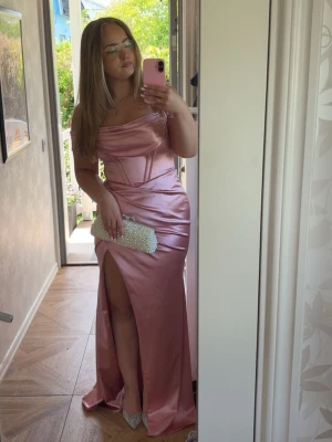 Rosa balklänning satin - Använd en gång, möjligtvis nån noppra här och var men i övrigt ska den vara hel. Nypris 4000kr på Dressroom Linné (studio). För referens är jag 162cm och då släpade den ganska rejält, och bär vanligtvis M/38 i alla kläder.