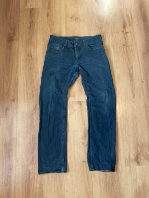 Mörkblå raka jeans - Säljer ett par mörkblå jeans med rak passform och klassisk femficksdesign. Jeansen har normal midja och detaljer i kontrastsömmar. Materialet är denim i bomull. Ställ fråga vid fundering, pris kan diskuteras🙏🙌