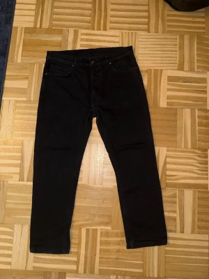 Svarta straight leg jeans - Säljer ett par svarta jeans med rak passform och klassisk femficksdesign. Jeansen har normal midja och är tillverkade i ett mjukt denimtyg, perfekta för en avslappnad och stilren look. Passar till det mesta och är ett måste i garderoben.