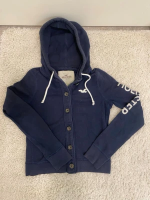 Vintage Hollister hoodie - Riktigt schysst och sällsynt hollister cardigan/hoodie med knappar. Modellen är 182 och passar inte! Skriv vid fundering/info!