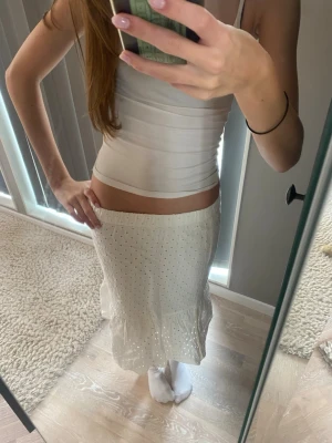 Vit långkjol med prickigt mönster - Supersöt vit långkjol med små prickar och volang nertill. Kjolen har en lätt och luftig känsla, perfekt för vår, skolavslutning och sommar. Resår i midjan för skön passform och flowig siluett. Jätte gullig och enkel att styla till vad som helst!💓🤗