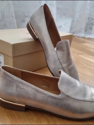 Bobbies light gold loafers - Classic, genuine leather soft gold loafers from bobbies. Only worn a few times, but 1 am unfortunately selling because I never wear them. They're a really muted gold colour, tried my best to capture it in the pictures. I have also added sole protectors to the bottom, which you can see in the last picture.