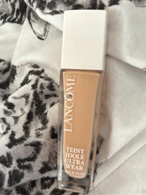 Lancôme Teint Idole Ultra Wear 115C - Foundation från Lancôme i nyansen 115C. Teint Idole Ultra Wear Care & Glow ger en naturlig glow och har SPF 25. Kommer i en rektangulär glasflaska med vit plastkork och rymmer 30 ml. Perfekt för dig som vill ha en lätt och fräsch bas med lång hållbarhet.Halva kvar inne