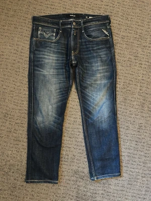 Replay anbass  - Väldigt sparsamt använda replay anbass jeans i 33/30. Sköna jeans som har en väldigt snygg färg. Perfekt nu till våren. Näst intill inga defekter förutom att man ser att de inte är helt nya! Bara att skriva vid övriga frågor. 