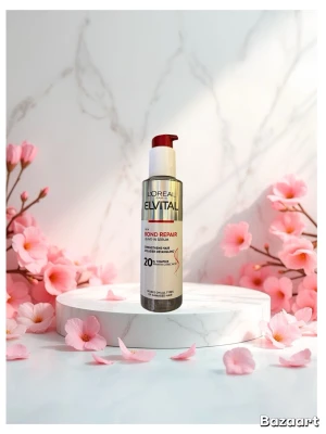 L'Oréal Elvital Bond Repair Serum - L'Oréal Elvital Bond Repair Leave-In Serum i en  silverfärgad pumpflaska med röda och vita detaljer. Serumet stärker och reparerar håret med citronsyra och passar alla hårtyper. Flaskan är smal och cylindrisk, tillverkad i plast. Har använt den typ 3-4 gånger. Hela är typ helt full.