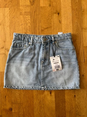 Ljusblå jeanskjol - Ljusblå jeanskjol i kort modell, aldrig använda. 