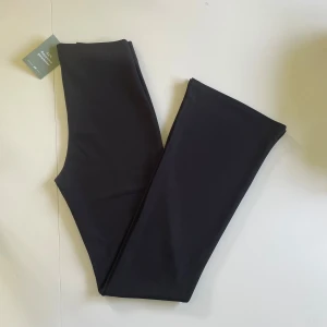 Bootcut byxa - Säljer svarta bootcutbyxor i trikå från h&m. Storlek S. Aldrig använda och har lappen kvar. Midjemått ca 67, innebenslängd ca 85. Highwaisted. Stretchigt material. Dold resor i midjan. Köparen betalar frakten!