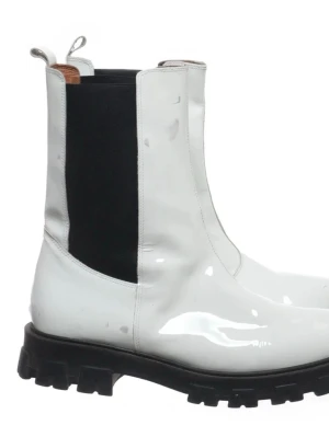 Twist & Tango, Vita chelsea boots i lack – chunky sula - Statement-boots i vit lack med kraftig svart räfflad sula. Chelsea-modell med resår i sidorna och dragflik bak för enkel av- och påtagning.   Bootsen har använts och har synliga märken och skav i lacken (3 mm bred), främst framtill och på sidorna. Går att tvätta bort.  Detta är kosmetiskt och påverkar inte funktionen. Se närbilder för detaljer.