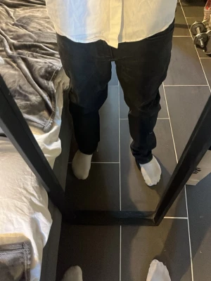 Svarta jeans från Blend - Säljer ett par svarta jeans från Blend med klassisk femficksdesign och normal passform. Jeansen har en lätt tvättad look och är tillverkade i denim med en snygg finish. Perfekta för dig som gillar en stilren och enkel look.