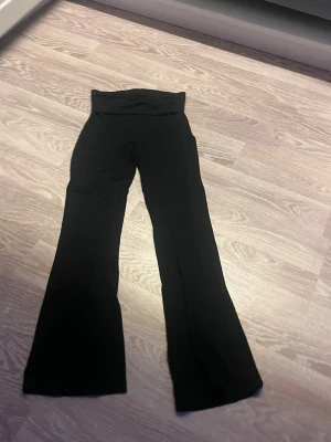 Svarta utsvängda leggings - Snygga svarta leggings med utsvängda ben och hög midja. Perfekta för en trendig och bekväm stil. Mjukt och stretchigt material som sitter skönt hela dagen.