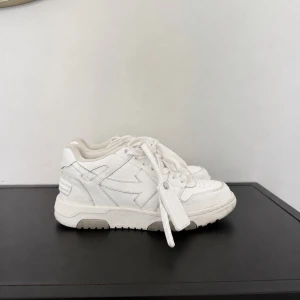 Vita Off-White sneakers Virgil Abloh - Säljer ett par vita sneakers från Off-White med den ikoniska pil-loggan på sidan. Skorna har chunky sula, rund tå och är tillverkade i läder med vita skosnören. Perfekta för dig som gillar streetwear och vill ha en clean look.