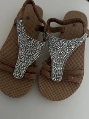 Brown embellished sandals  - Brown embellished sandals   Size: 39 Condition: new, never worn  Details: comfortable flat sandals with sparkly rhinestone details, perfect for summer and vacation  💰 Price: 100 kr  📦 Fast shipping / meet-up possible Message me if interested 💌