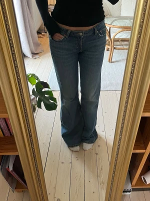 Lågmidjade bootcut jeans  - Lågmidjade bootcut jeans i modellen ”Nova” från weekday, lätt slitna längst ner (se bild). W27/L32