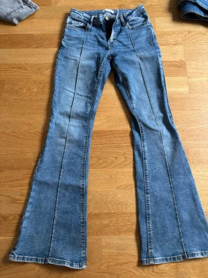 Blåa bootcut jeans mid waist - Super fina blåa bootcut jeans med jättesnygga bakfickor!