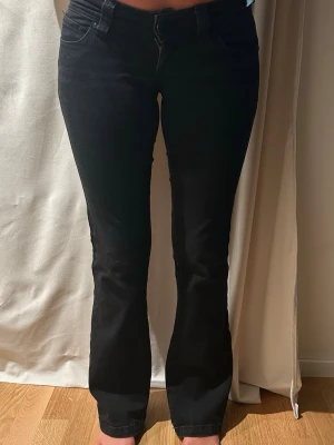 Svarta low waist bootcut jeans - Säljer ett par supersnygga svarta lågmidjade bootcut jeans från abrand (00 super low kick). Storlek 24/au 6 Tall. Jag är 164cm lång.
