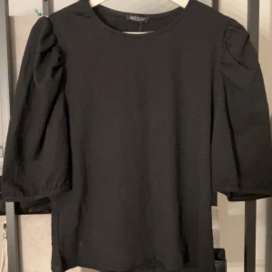 Svart topp med puffärmar från Missäy - Snygg svart topp från Missay med puffärmar. Aldrig använd💞