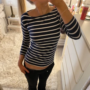 Trekvartsärmad boatneck topp - Så fin randig topp i marinblått och vitt. Trekvartsärmar och en båtformad halsringning. 🤍