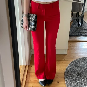 Röd kostymbyxa - Säljer ett par snygga röda kostymbyxor från Zara i storlek XS. Byxorna har en klassisk rak passform med pressveck❤️