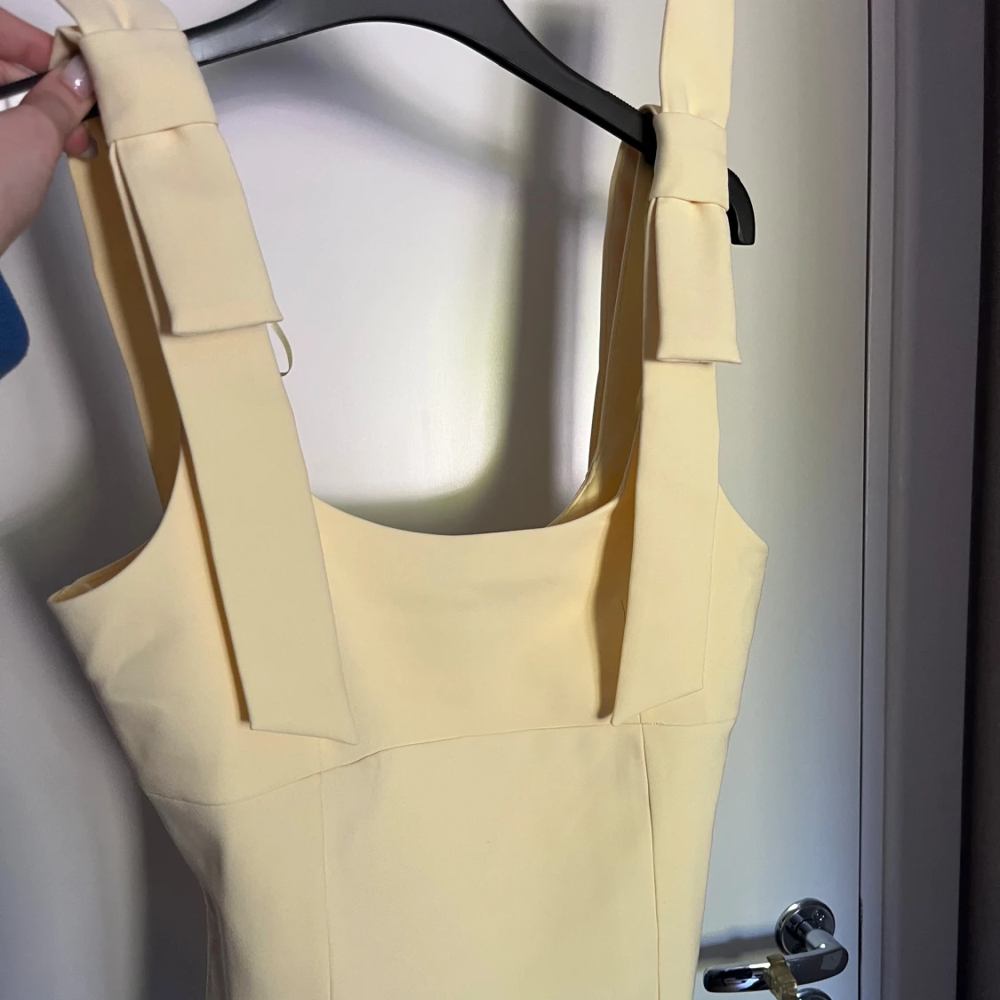 Ljusgul topp med rosetter på axelbanden