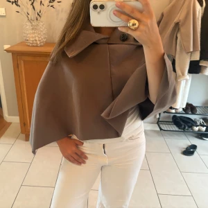 Brun poncho med knappar - Brun snygg poncho