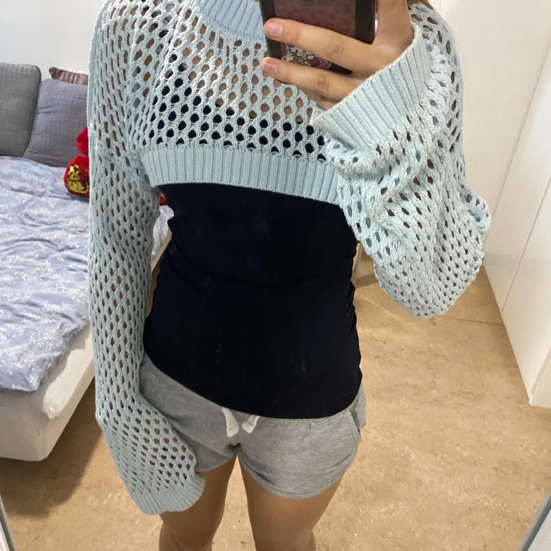 Ljusblå stickad croppad väst