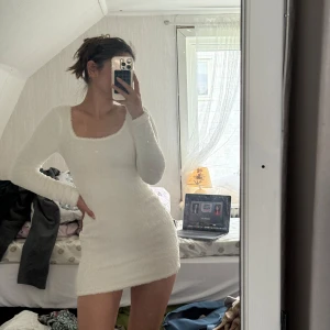Vit fluffig kortklänning  - Supermysig vit kortklänning från SHEIN i fluffigt och mjukt polyestermaterial. Klänningen har långärmade ärmar, rundad fyrkantig urringning och en tight passform som framhäver figuren. Perfekt för dig som gillar comfy vibes och vill sticka ut med en enkel men snygg look.