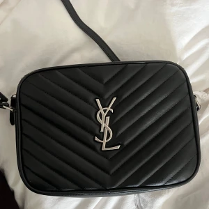 Svart ysl väska - Super snygg väska i mycket bra skick, väskan är ej äkta. knappt använd. För mer bilder är det bara att fråga. Priset kan diskuteras