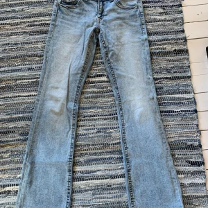 Ljusblå bootcut jeans Gina Tricot - Snygga ljusblå jeans från Gina Tricot i bootcut-modell. Jeansen har klassisk femficksdesign, normal passform och är tillverkade i mjukt denimtyg. Perfekta för dig som gillar en retroinspirerad look med utsvängda ben.