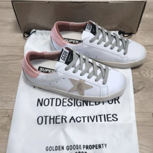 Golden Goose skor vit/rosa - ⭐Supersnygga Golden Goose Superstar skor i vit och ljusrosa💝. De är i väldigt fint skick och redo för en ny ägare.                                                          📏Storlek: 37                                                  Meddela för fler bilder, frågor, eller pris                            