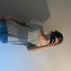 Ljusgrå basic t-shirt - En enkel ljusgrå t-shirt från H&M med lös passform och korta ärmar. T-shirten har en klassisk rund halsringning och är tillverkad i mjuk bomull, perfekt för en avslappnad stil. Jag köpte tröjan några månader sedan och klippte i den. Jag har använt tröjan nästan inga gånger.