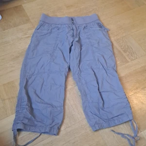 Bruna cargobyxor  - Säljer ett par brun/grå byxor från H&M i storlek 38. Byxorna har bred resår i midjan, flera fickor och snörning vid bensluten. 🩷