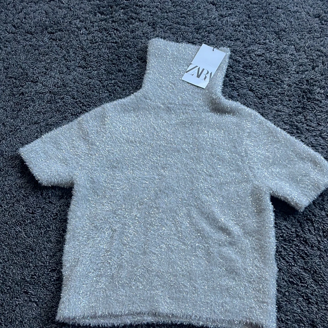 Glittrig polotröja från Zara