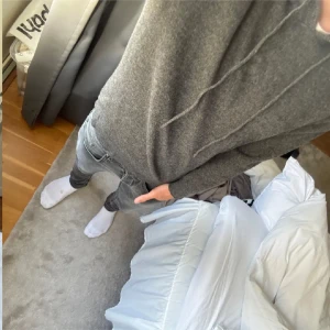 Mörkgrå hoodie i mjuk ullmix - Säljer en stilren mörkgrå hoodie med huva och dragsnören. Tröjan är långärmad och har en mjuk, stickad känsla som passar perfekt för kyligare dagar. Enkel och clean look som funkar till det mesta. Perfekt för dig som gillar minimalistisk stil.