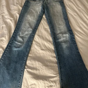 Bootcut jeans - Bootcut jeans i storlek 34, har ett hål som lätt går att sy ihop och två fläckar som inte syns när man har på sig de