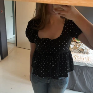 Svart prickig blus med puffärm - Supersöt svart blus med vita prickar och puffiga korta ärmar. Priset kan diskuteras🩷