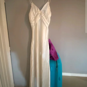 Balklänning  - Nytt skick, creme vit, skulle beskriva det som silkes material 