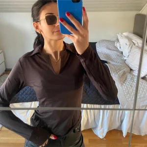 Brun långärmad ”skims” tröja - Snygg brun långärmad tröja med klassisk krage. Perfekt för en stilren look. Passar bra till både jeans och kjol. Liknar skims i materialet