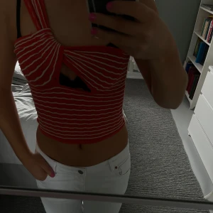 Röd- och vitrandig topp från Zara - Säljer en snygg röd- och vitrandig topp från Zara. twistdetalj framtill och breda axelband.  Så fin till sommaren. Aldrig använd