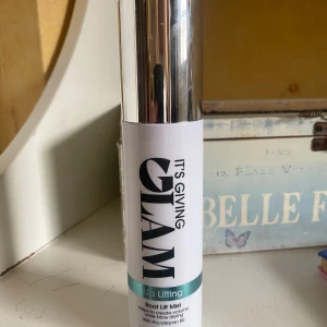 Root Lift Mist från It's Giving Glam - Använt ganska lite se bild 3! Root Lift Mist som hjälper till att skapa volym vid föning. Innehåller Pro-Vitamin B5 och är vegansk. Flaskan rymmer 150 ml och har en stilren design med silverfärgat lock.