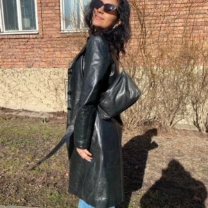Svart lång skinn trenchcoat - Säljer en svart lång trenchcoat i skinn med bälte i midjan. Jackan har knappar framtill och är helsvart med klassisk passform. Perfekt för dig som vill ha en edgy och tidlös look.🧚🏽🌸