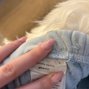 Ljusblå mjukisbyxor från Gina Tricot - Säljer ett par ljusblå mjukisbyxor från Gina Tricot med resår i midjan och vid bensluten. Perfekta för en chill dag hemma eller när du vill vara extra bekväm. Mjukt material och enkel design.
