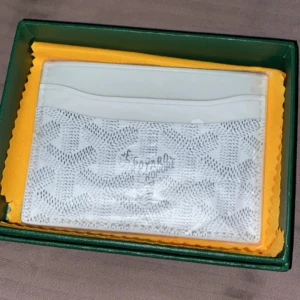 Vit Märkes Kortfodral  - Säljer ett stilrent vitt kortfodral med klassiskt mönster. Perfekt för att hålla ordning på korten i en smidig och snygg accessoar. Kommer i originalask.