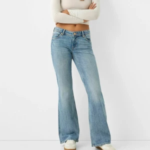 Ljusblå bootcut jeans - Säljer ett par ljusblå bootcut jeans med låg midja och klassisk femficksdesign. Jeansen har en lätt utsvängd passform nertill och är tillverkade i denim. Perfekta för en avslappnad och trendig look.